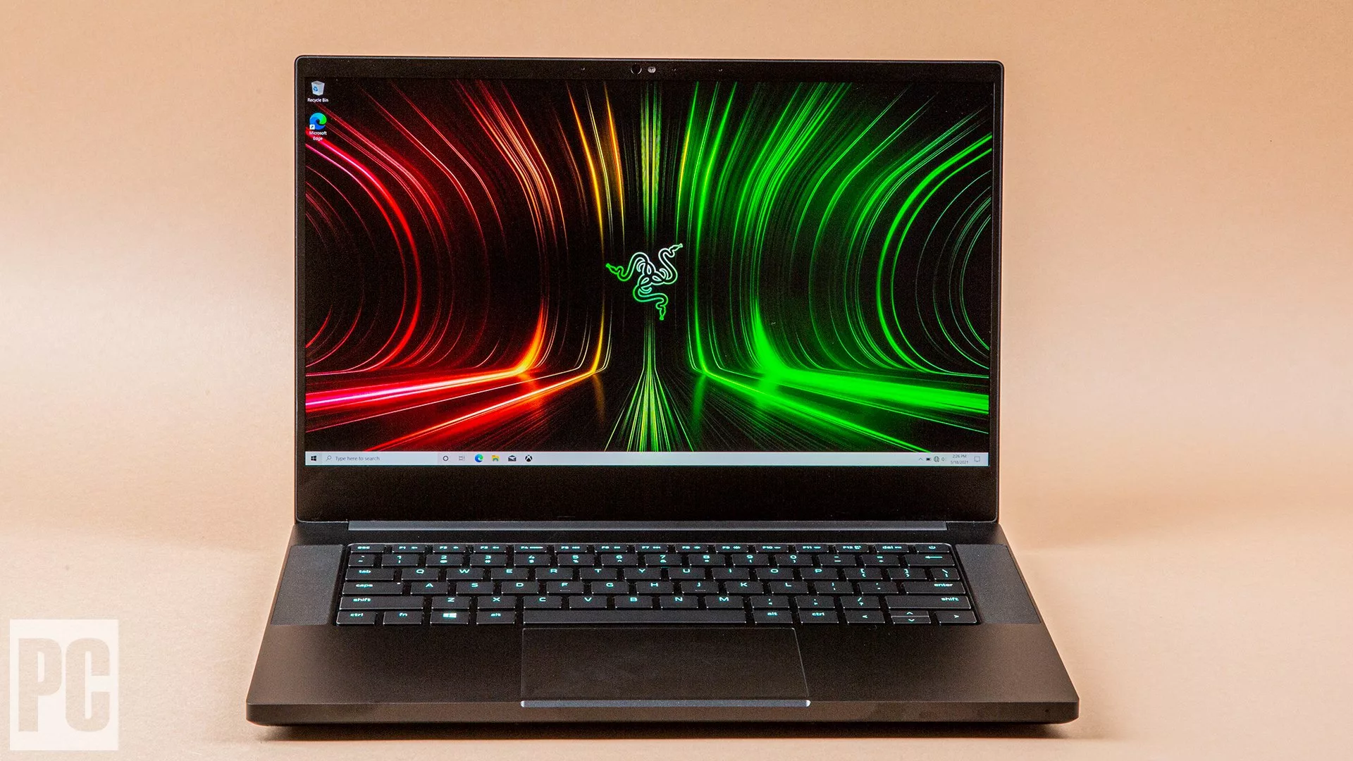 Aesthetic digital artwork showcasing the sleek and modern Razer Blade 14 gaming laptop against a futuristic background with neon accents.