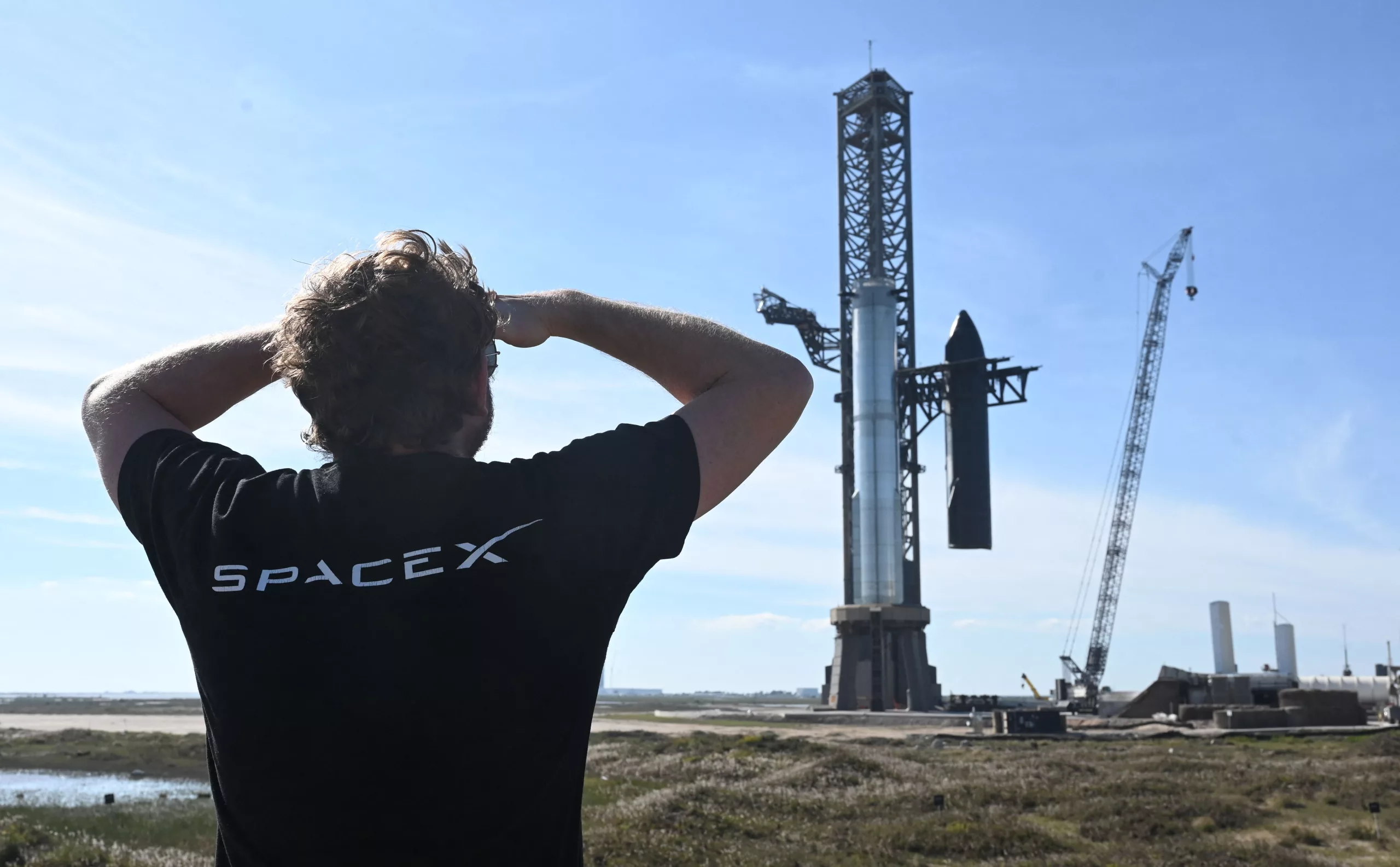 High-quality illustration of SpaceX Starship on launch pad with engineers, showcasing a modern rocket launch process.