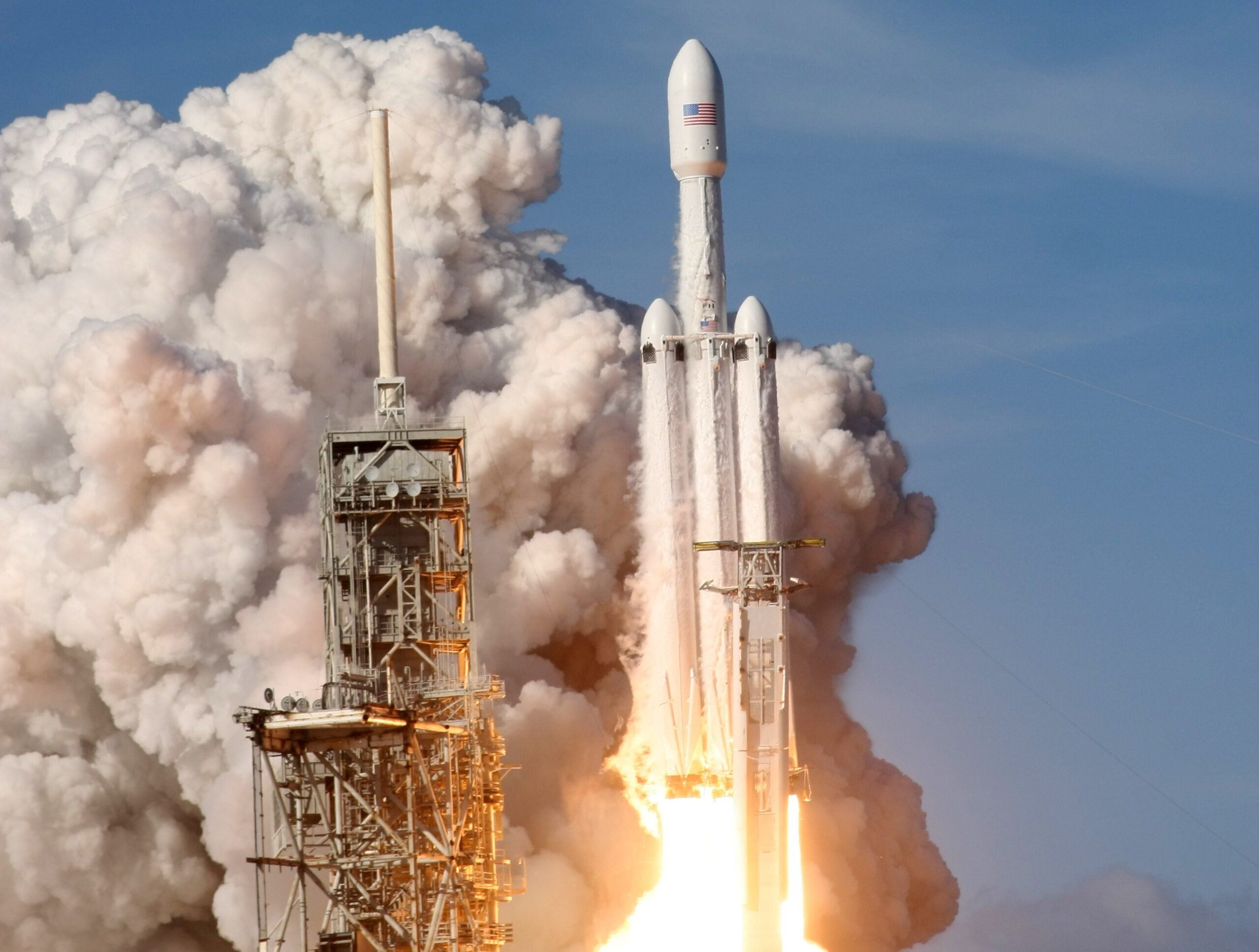SpaceX Starship rocket on the launch pad at Boca Chica, Texas, under cloudy skies, reflecting a tense atmosphere before the postponed launch.