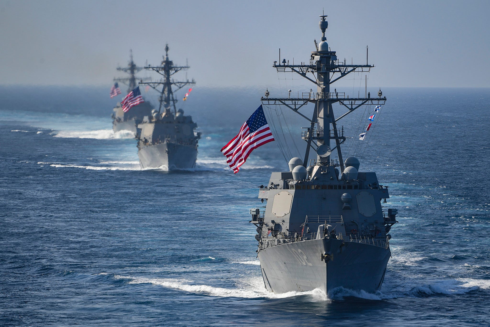 Illustration of a U.S. Navy officer reading a confidential email about the ban on China's DeepSeek AI platform, with naval ships in the background.