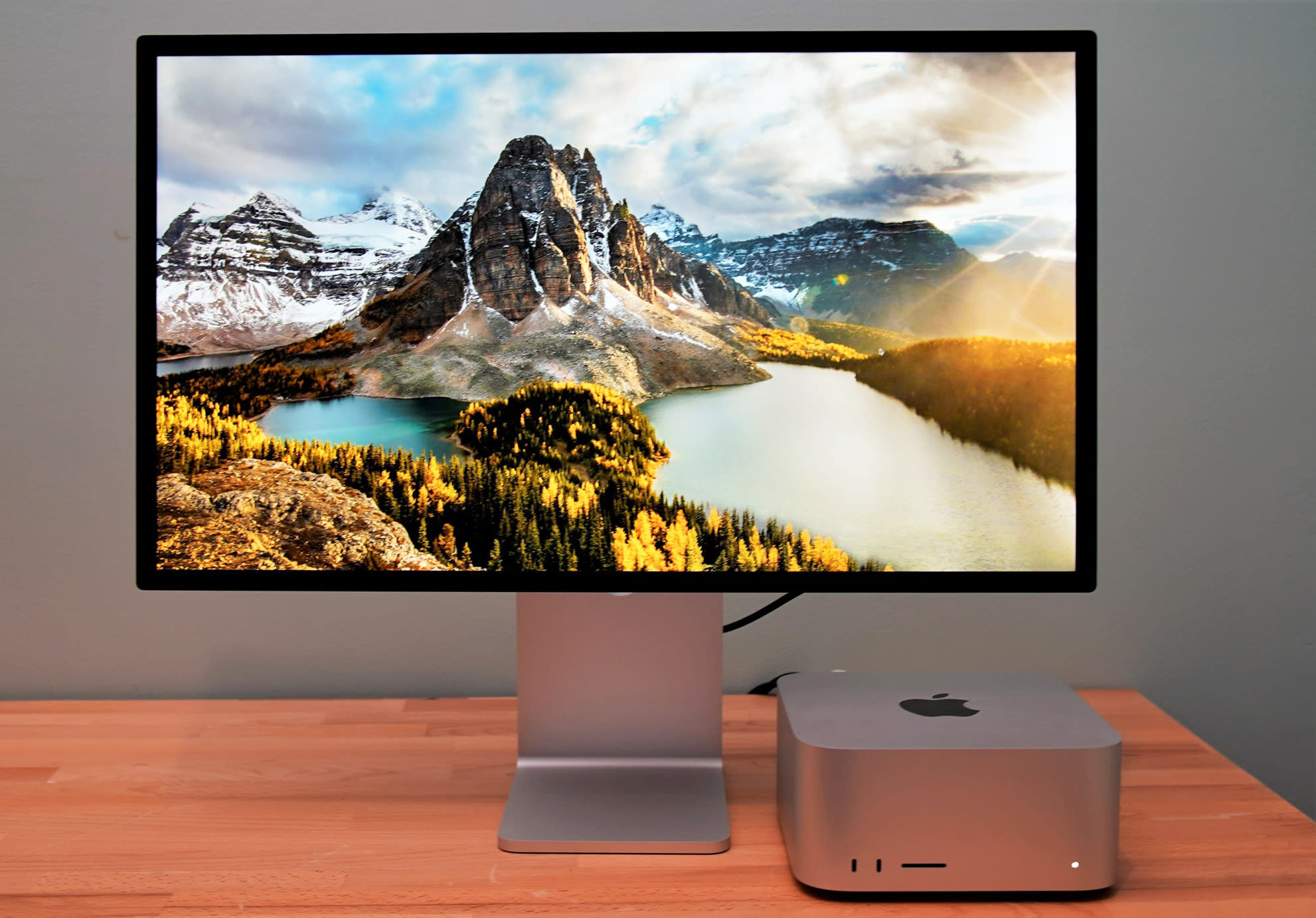 A modern workspace featuring the Apple Studio Display, showcasing its sleek design and high-resolution screen.