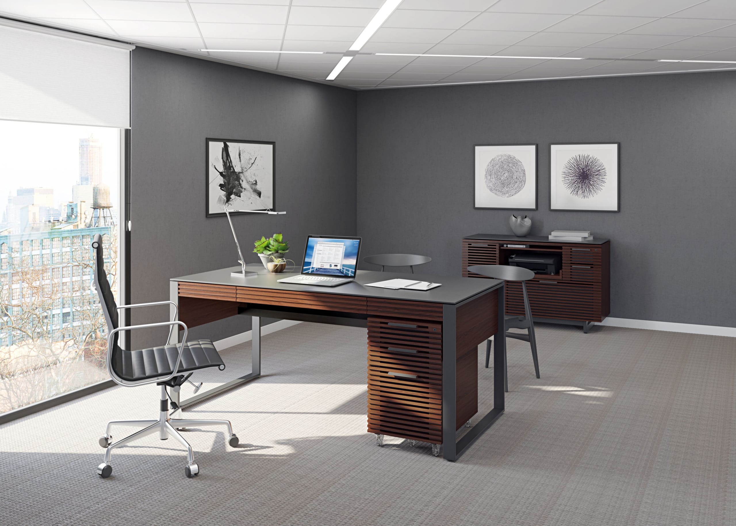 A modern workspace with a wall-mounted PC setup, showcasing a minimalist desk and creative decor.