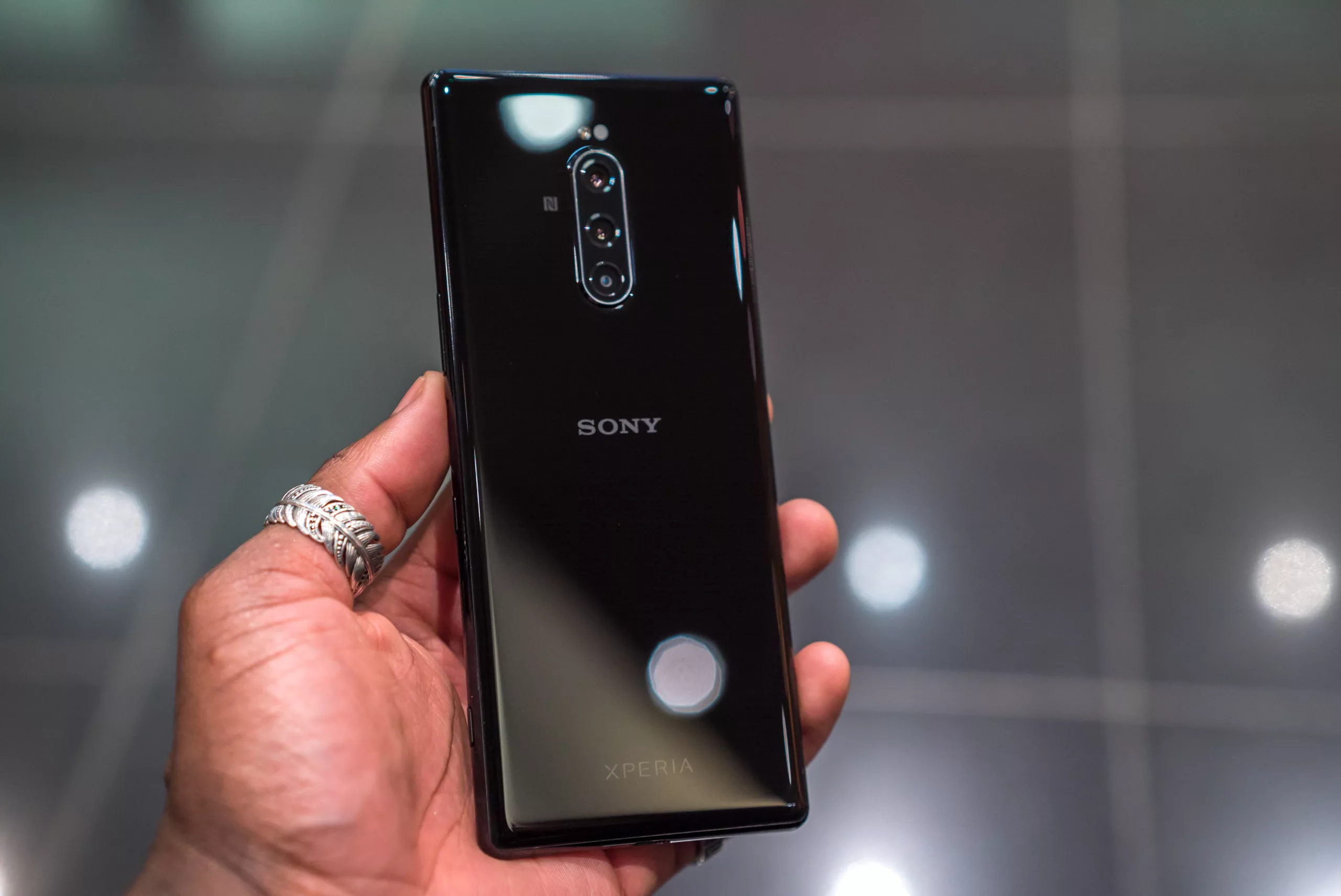 A modern and aesthetic visual featuring Sony Xperia flagship smartphone design and production details.