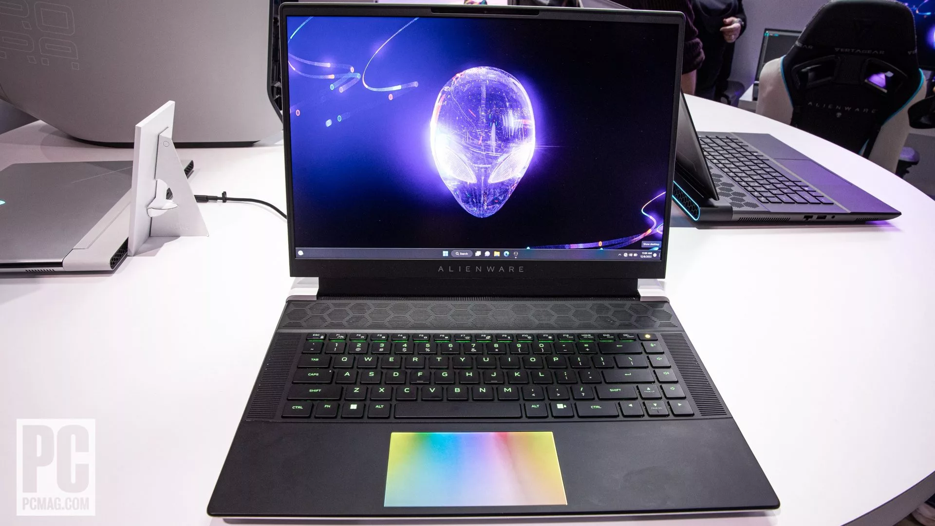 A stunning and modern illustration of the Alienware 16 gaming laptop set in a vibrant cybernetic cityscape, showcasing its sleek design and gaming capabilities.