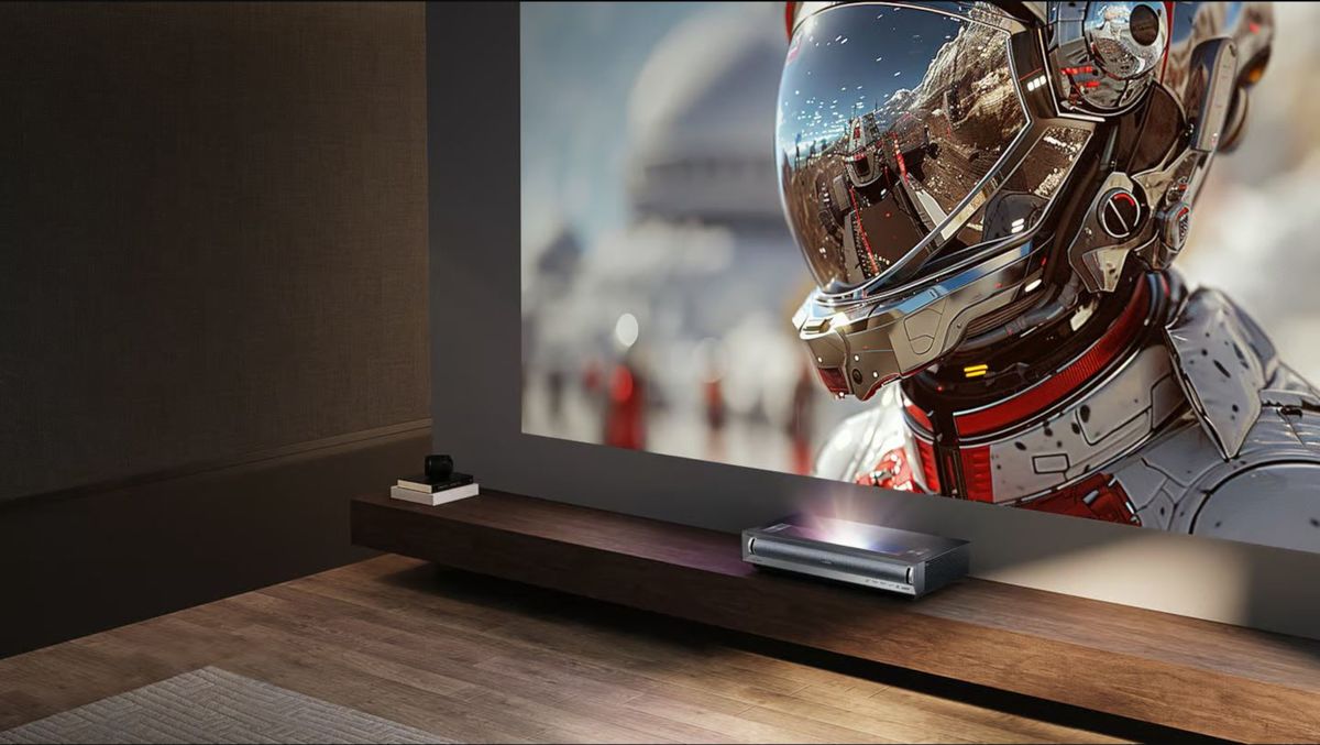 A modern gaming setup featuring the Hisense M2 Pro 4K Laser Projector showcasing vibrant graphics on a large screen.