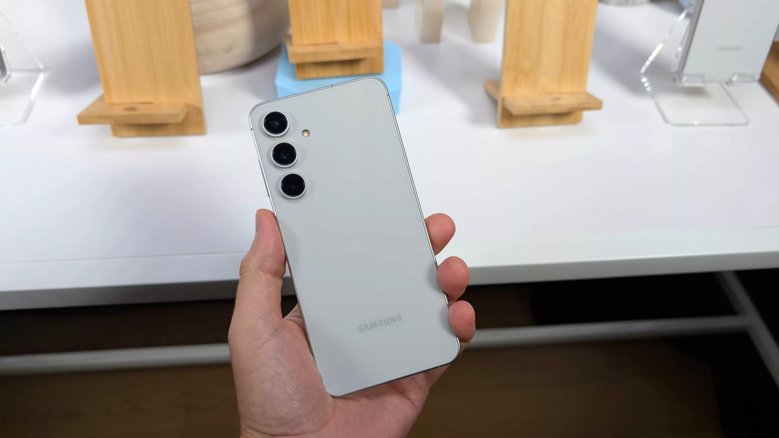 A high-quality digital illustration of Samsung Galaxy S25 FE with Exynos 2400 showcasing a sleek and modern design in a minimalist tech environment.