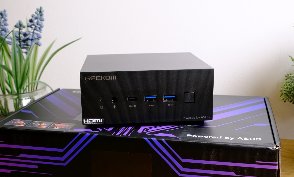 A modern and sleek Geekom A6 Mini PC displayed on a stylish desk, showcasing its compact design and advanced technology.