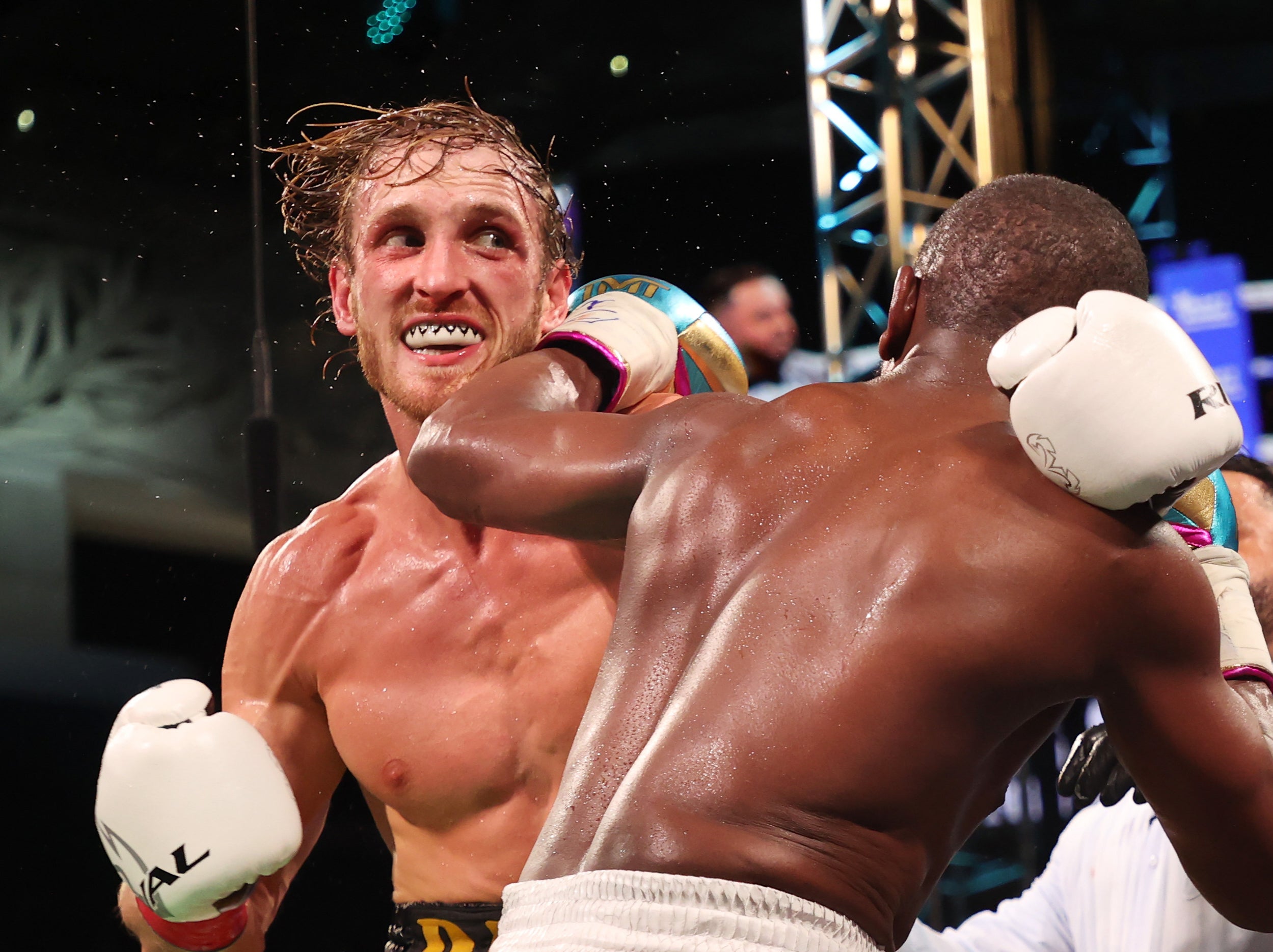 Promotional poster for the boxing match between Logan and Jake Paul, featuring vibrant colors and dynamic design.