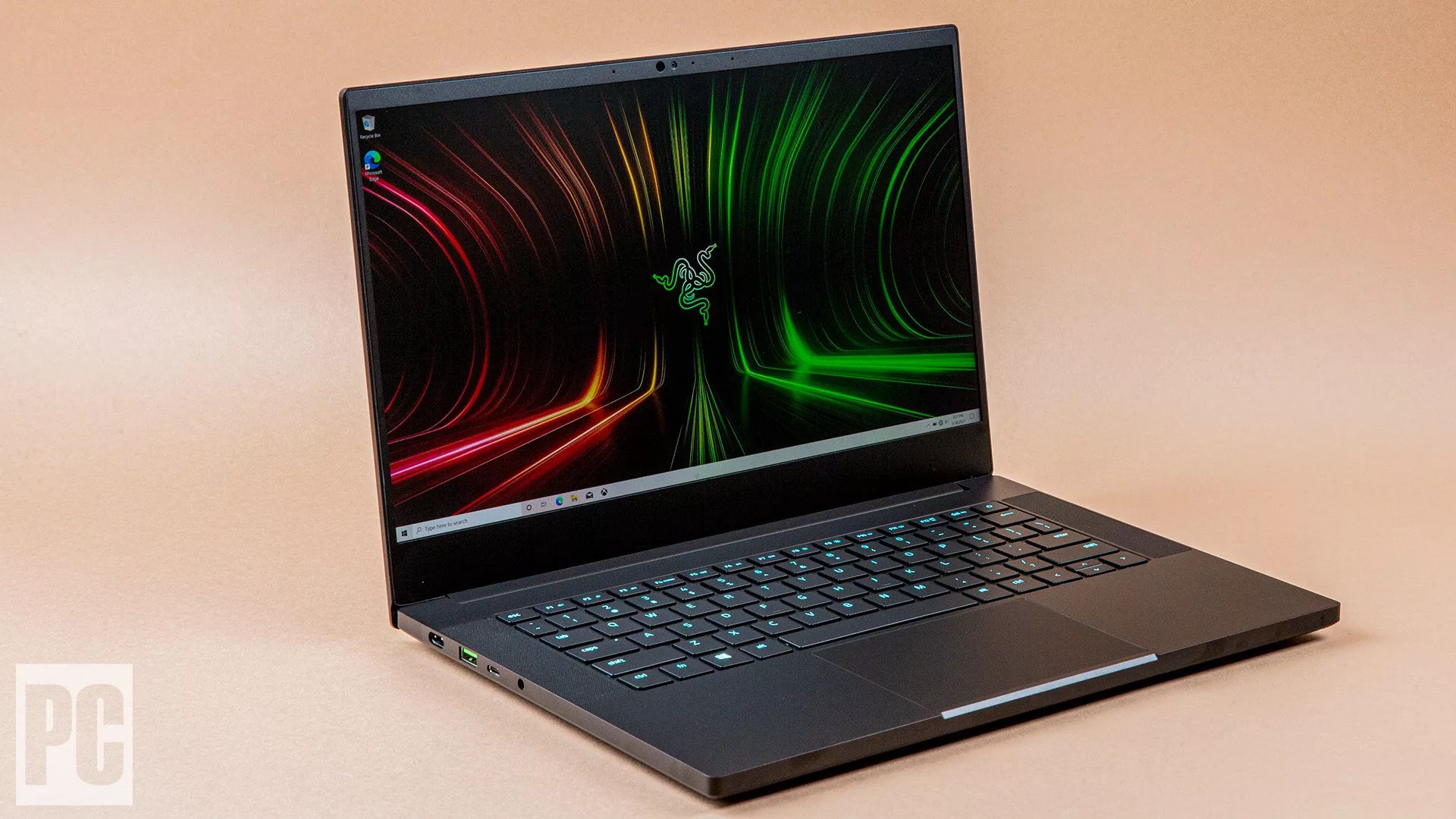 A modern and stylish Razer Blade 14 gaming laptop setup with highlights, suitable for social media content.