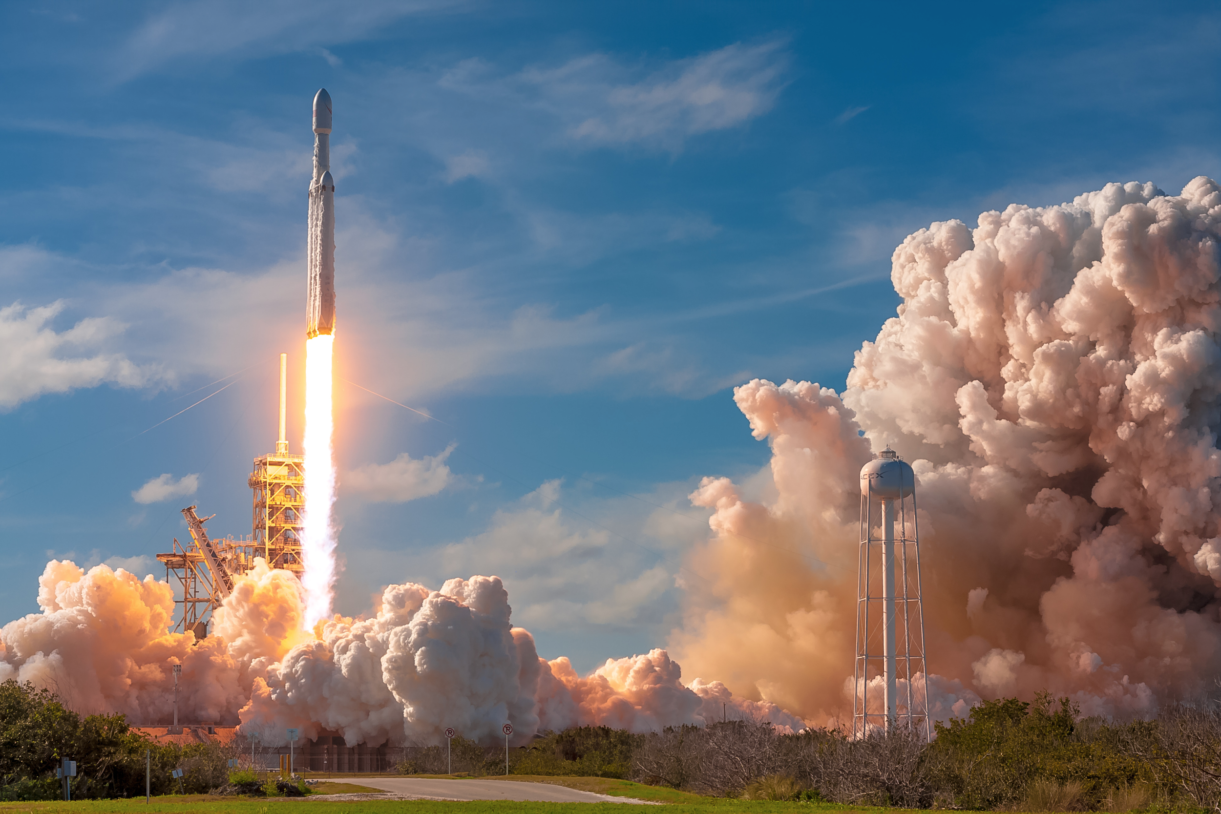 A SpaceX Falcon 9 rocket launching from Vandenberg Space Force Base into a night sky filled with stars and smoke, showcasing the excitement of space exploration.