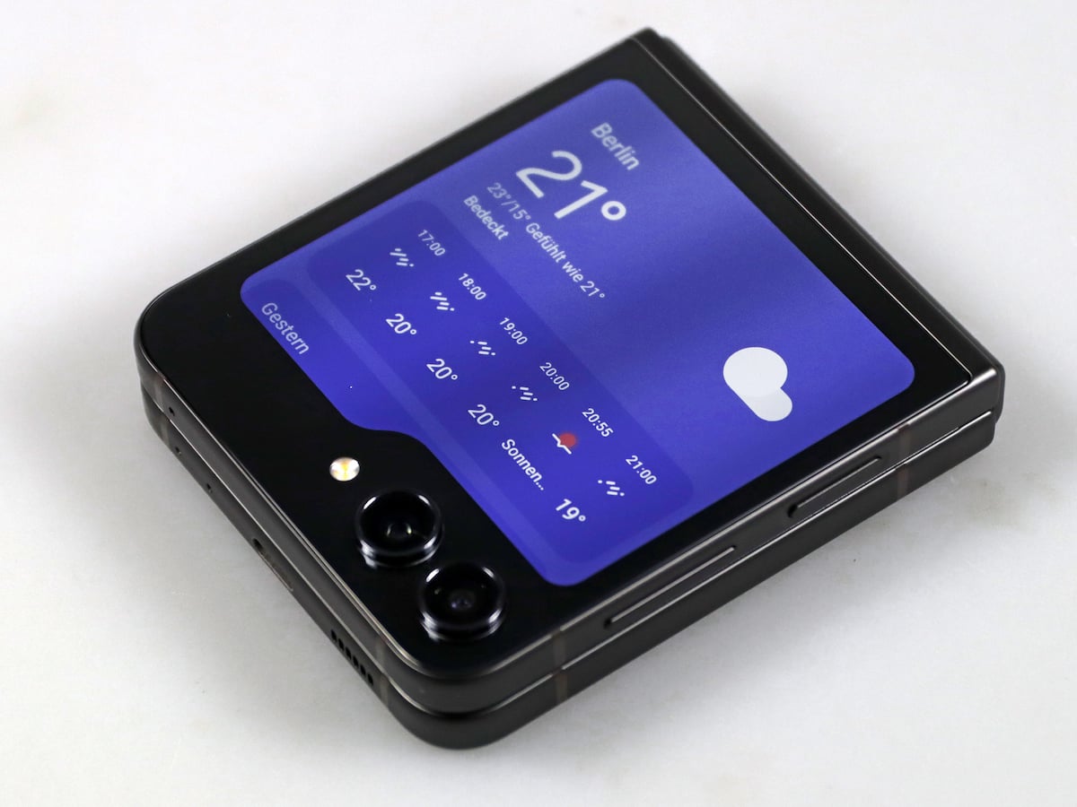 Illustration of Samsung Galaxy Z Flip FE with modern tech elements, showcasing a foldable screen design.