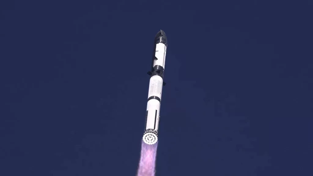 Preparations for SpaceX Starship Flight 9 with engineers and the rocket on the launch pad against a starry sky.