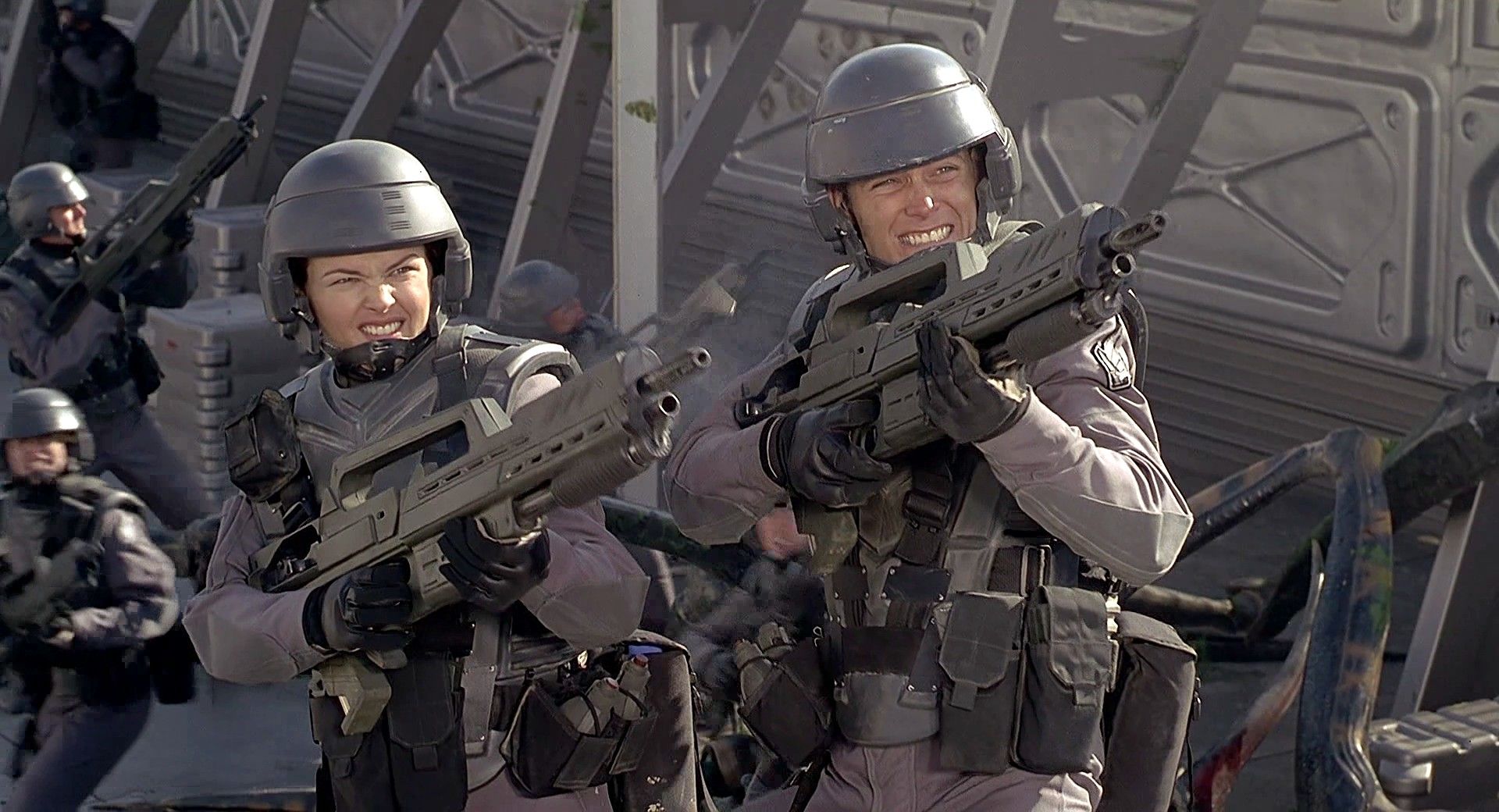 Futuristic visual inspired by Starship Troopers featuring soldiers in armor battling alien creatures.