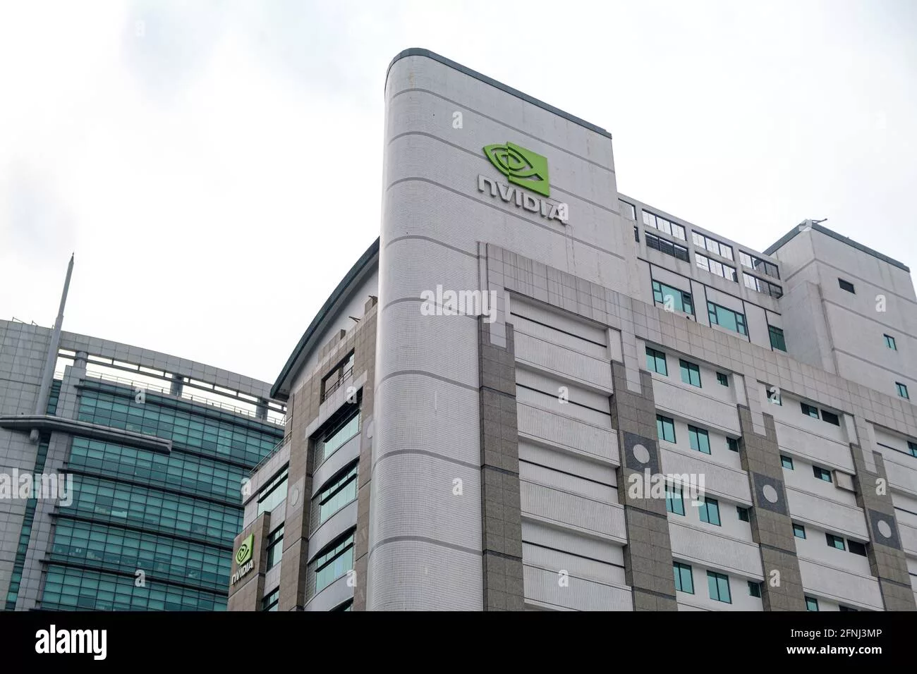 A futuristic representation of NVIDIA's Taiwan headquarters, featuring modern architectural design and green technology elements.